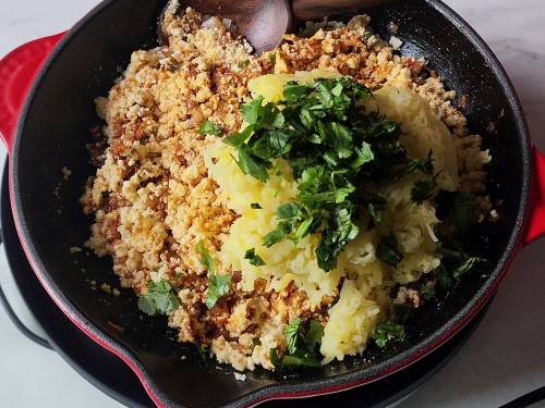 adding potatoes to sauteed ingredients