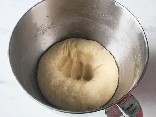 punched dough in a mixing bowl