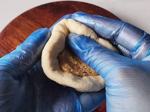 pushing the stuffing into the dough