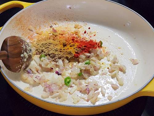 adding spices to the pan