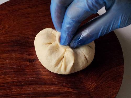 sealing the naan dough with keema