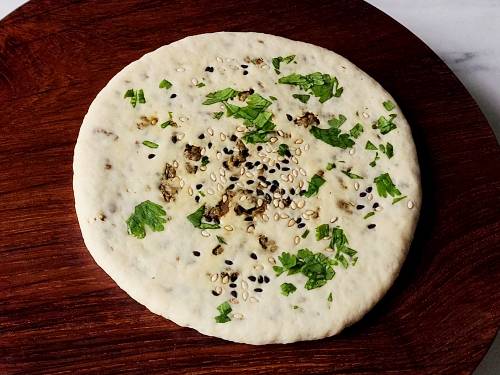 rolled keema naan on a rolling board
