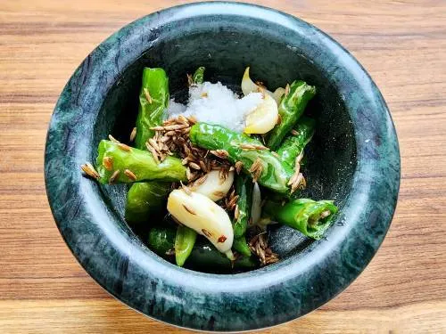 making thecha in stone mortar pestle