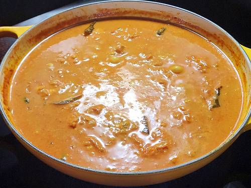 simmering meen curry with coconut milk