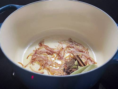 caramelising onions to make the pulao
