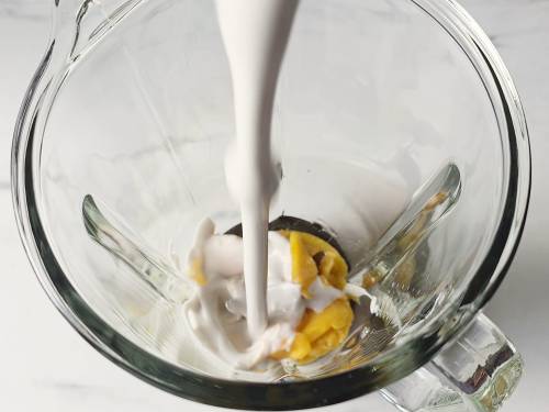 coconut milk and mango in a blender