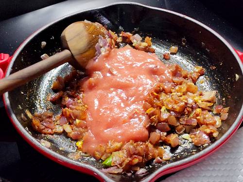 adding pureed tomatoes