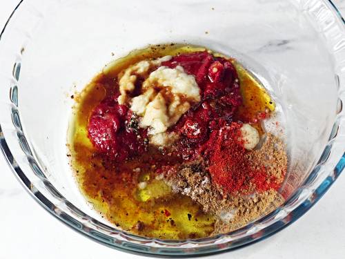 adding ingredients to a marinade bowl